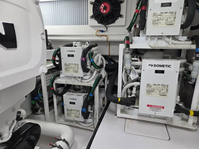 Slide: The Image of Engine room of a 2023 Viking Convertible with Dometic air conditioning units. - 34