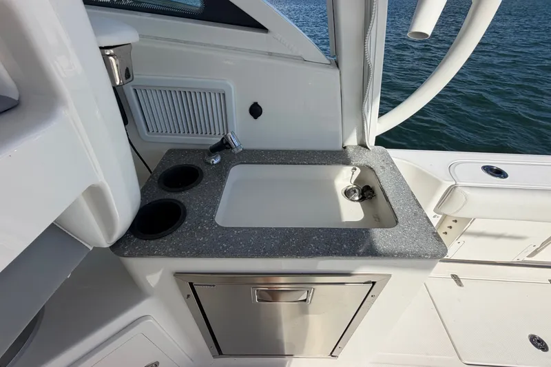 Slide: The Image of Boston Whaler 315 Conquest 2014 boat sink and countertop with ocean view. - 19