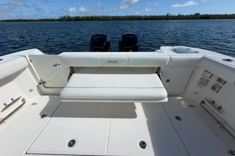 Slide: The Image of 2014 Boston Whaler 315 Conquest boat interior with seating and ocean view. - 13
