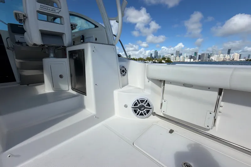 Slide: The Image of 2014 Boston Whaler 315 Conquest interior with city skyline in background. - 17