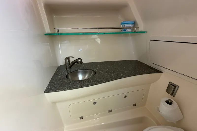 Slide: The Image of 2014 Boston Whaler 315 Conquest bathroom with sink, countertop, and shelf. - 51