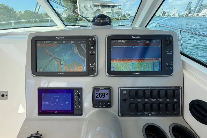 Slide: The Image of Control panel of a 2014 Boston Whaler 315 Conquest with navigation screens and gauges. - 32