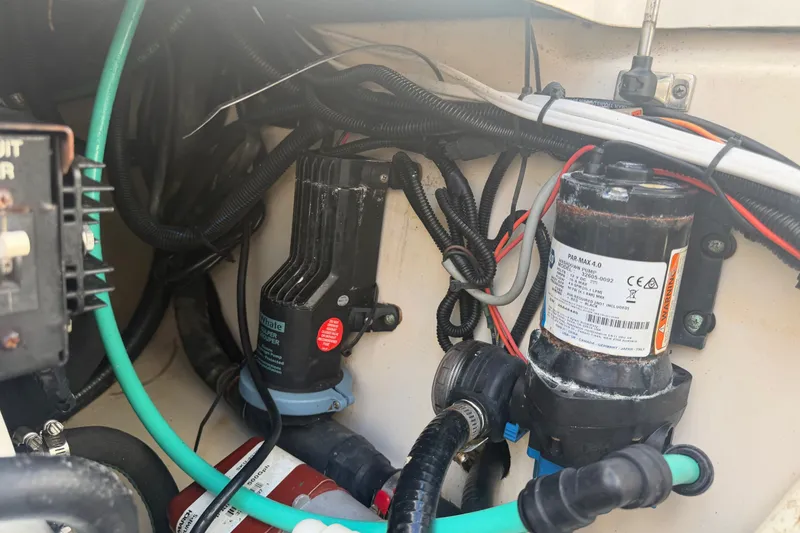 Slide: The Image of Engine compartment of a 2014 Boston Whaler 315 Conquest with visible wiring and components. - 65