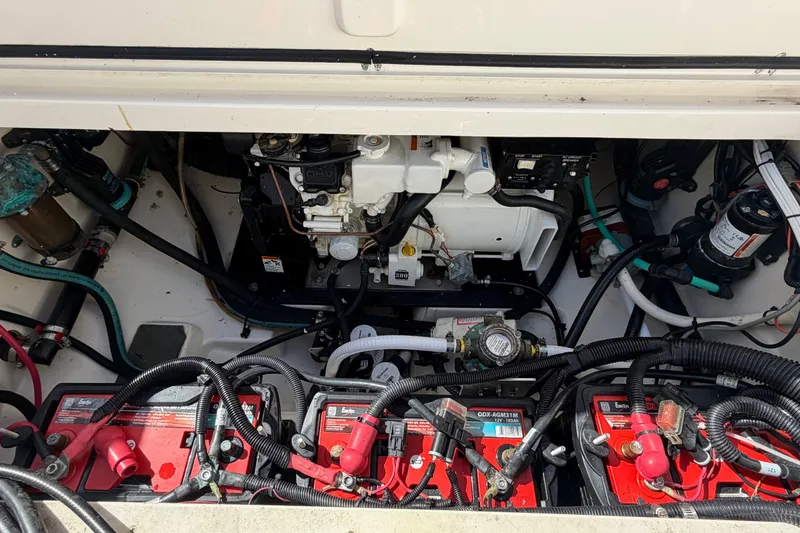 Slide: The Image of Engine compartment of a 2014 Boston Whaler 315 Conquest with visible batteries and wiring. - 62