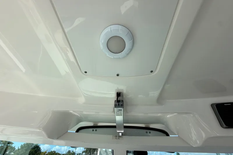 Slide: The Image of 2014 Boston Whaler 315 Conquest interior ceiling detail with mounted light fixture. - 38
