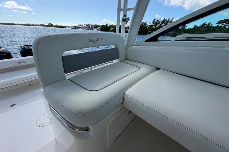 Slide: The Image of 2014 Boston Whaler 315 Conquest boat seating with scenic water view. - 42