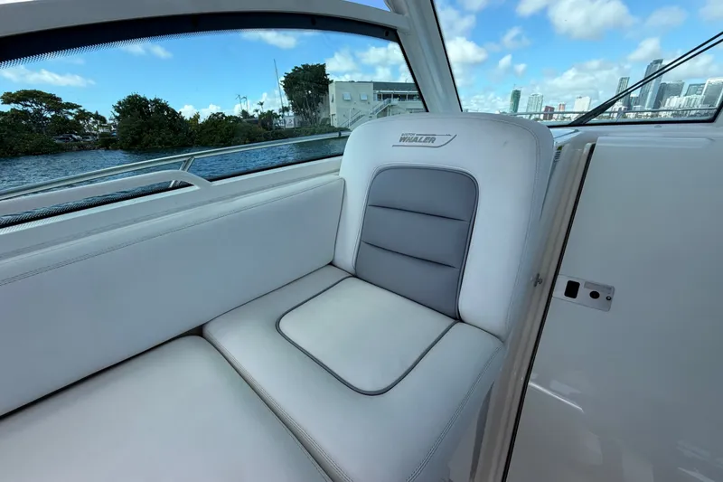 Slide: The Image of Interior seating of a 2014 Boston Whaler 315 Conquest boat with waterfront view. - 43