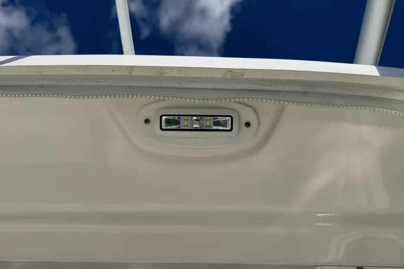 Slide: The Image of LED light fixture on a 2014 Boston Whaler 315 Conquest boat under a clear sky. - 24