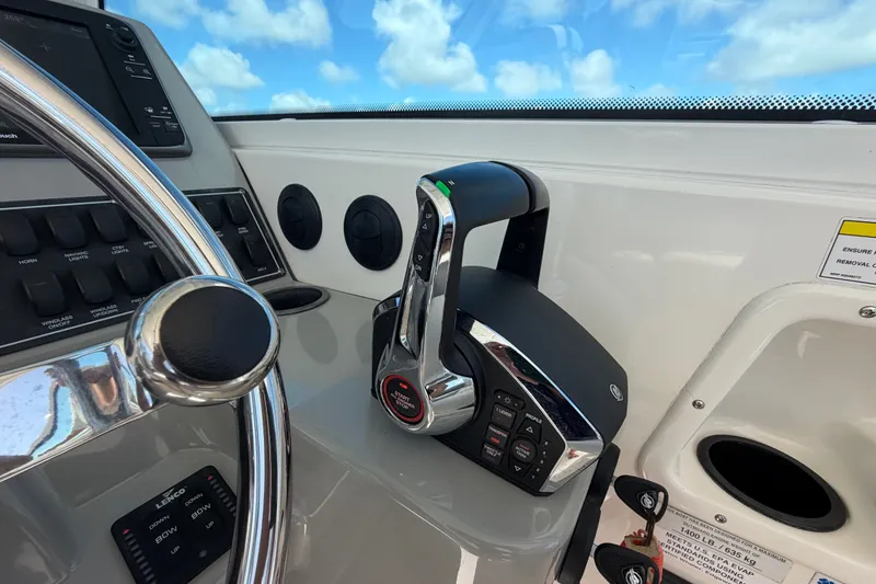 Slide: The Image of Helm controls of a 2014 Boston Whaler 315 Conquest with steering wheel and throttle. - 29
