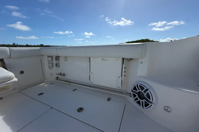 Slide: The Image of 2014 Boston Whaler 315 Conquest boat interior with seating and speaker under clear sky. - 15