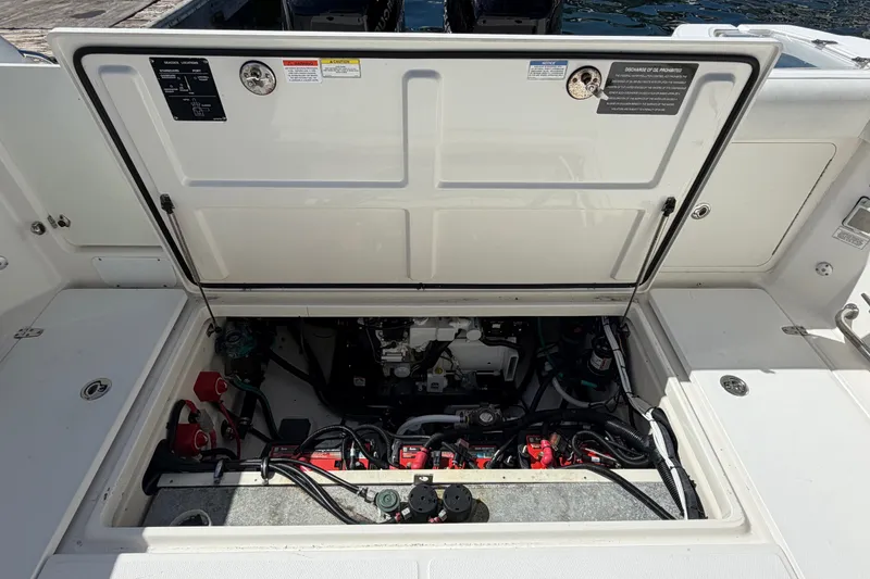 Slide: The Image of Open engine compartment of 2014 Boston Whaler 315 Conquest boat, showing mechanical components. - 61