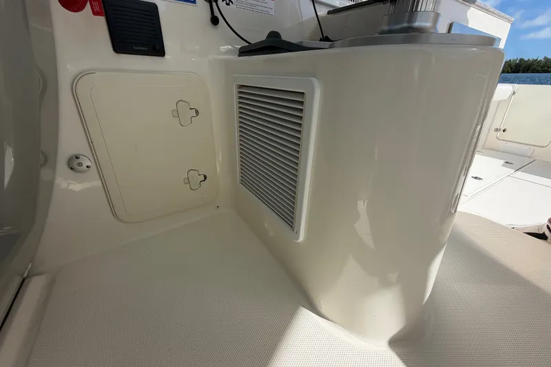 Slide: The Image of 2014 Boston Whaler 315 Conquest interior detail with storage compartment and vent. - 40