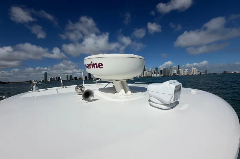 Slide: The Image of 2014 Boston Whaler 315 Conquest boat with radar, city skyline in background. - 60