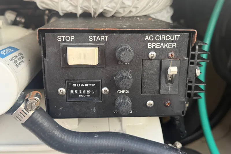 Slide: The Image of Control panel with stop/start buttons and AC circuit breaker on a 2014 Boston Whaler 315 Conquest. - 64