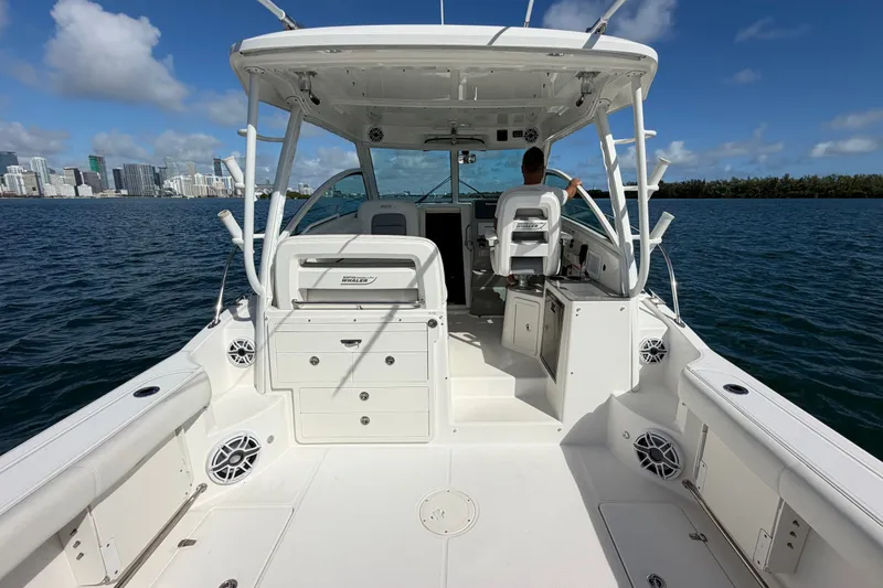 Slide: The Image of 2014 Boston Whaler 315 Conquest boat on water, city skyline in background. - 14