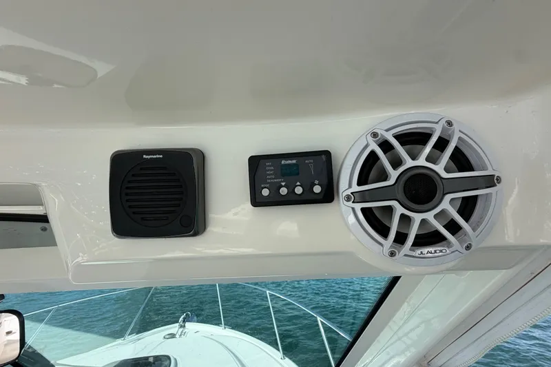 Slide: The Image of 2014 Boston Whaler 315 Conquest dashboard with Raymarine speaker and JL Audio system. - 37