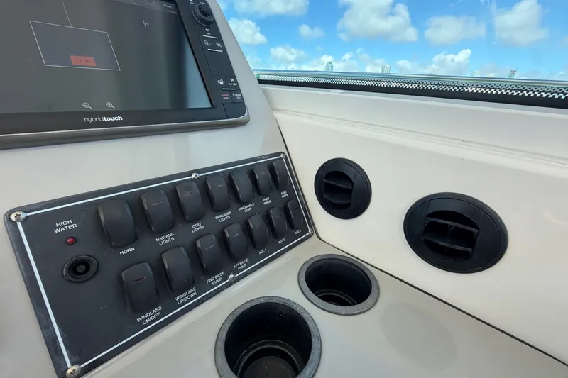 Slide: The Image of Control panel of a 2014 Boston Whaler 315 Conquest boat with switches and vents. - 30