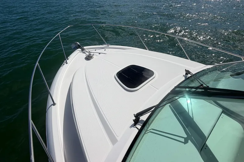 Slide: The Image of 2014 Boston Whaler 315 Conquest boat deck on water, sunny day. - 56