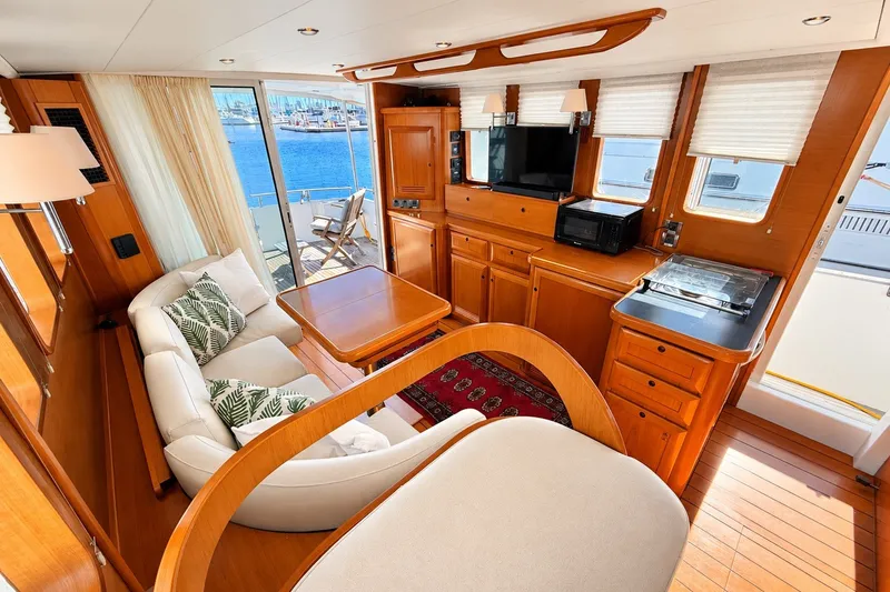 Slide: The Image of Luxurious interior of a 2005 Beneteau Swift Trawler 42 with elegant wood finishes. - 13
