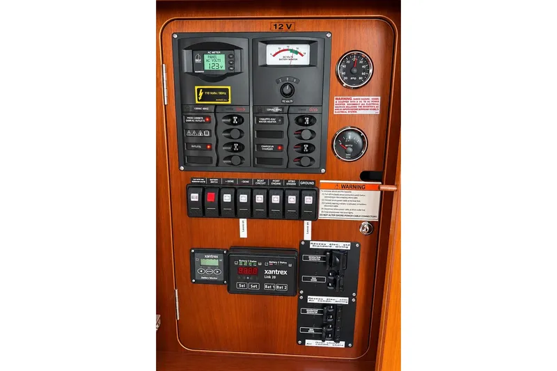 Slide: The Image of Electrical control panel of a 2005 Beneteau Swift Trawler 42, featuring various switches and gauges. - 23