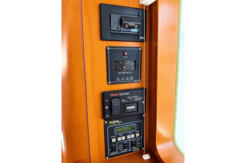 Slide: The Image of Electrical control panel on a 2005 Beneteau Swift Trawler 42, featuring Onan GenSet and ProSine displays. - 22