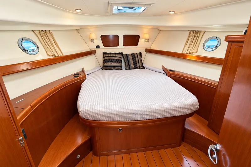 Slide: The Image of Luxurious cabin interior of 2005 Beneteau Swift Trawler 42 with wood finish and cozy bed. - 16