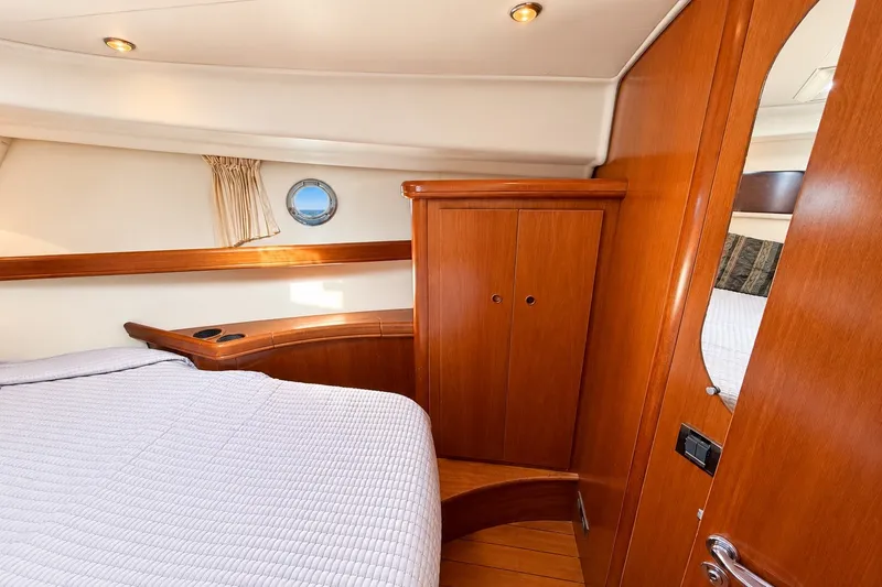 Slide: The Image of Cozy cabin interior of 2005 Beneteau Swift Trawler 42 with wood finish and porthole. - 17