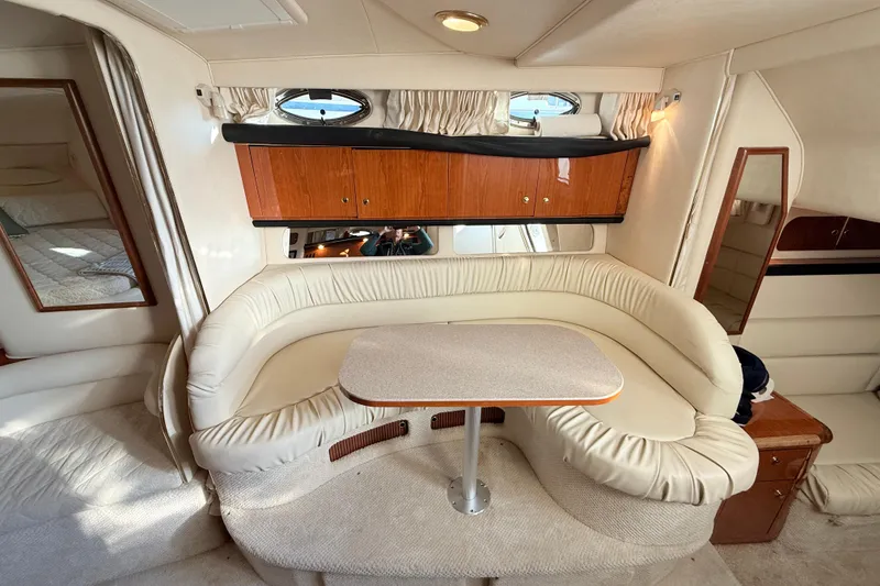 Slide: The Image of Interior of 2001 Sea Ray 340 Sundancer with cream seating and wooden cabinetry. - 17