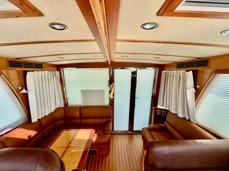 Slide: The Image of Interior of the 2016 Sabre 48 Salon Express with leather sofas and a wooden table. - 28