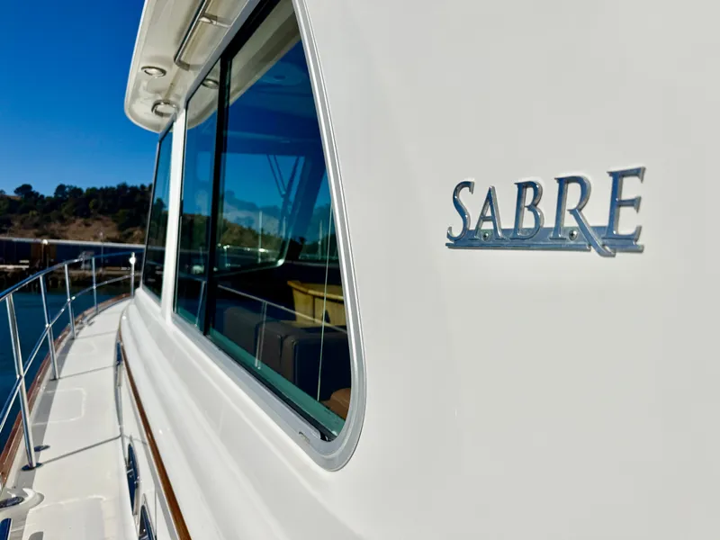 Slide: The Image of Side view of the 2016 Sabre 48 Salon Express with a shiny emblem. - 42