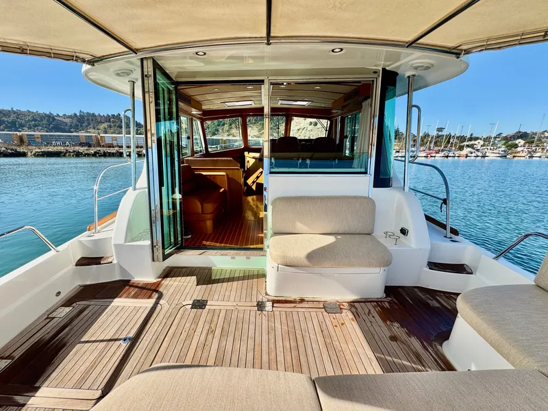 Slide: The Image of The 2016 Sabre 48 Salon Express features an elegant aft deck with comfortable seating. - 14