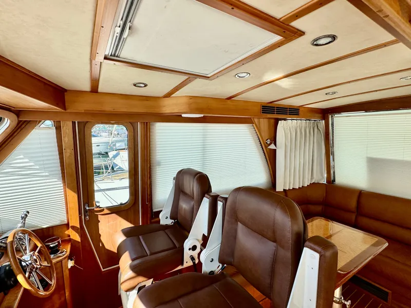 Slide: The Image of Interior of the 2016 Sabre 48 Salon Express with leather seats and wooden table. - 27
