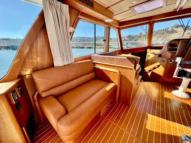 Slide: The Image of Interior of the 2016 Sabre 48 Salon Express with leather sofa and wooden flooring. - 17