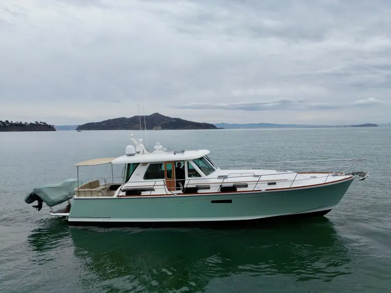 Slide: The Image of 2016 Sabre 48 Salon Express on calm water with a cloudy sky in the background. - 5