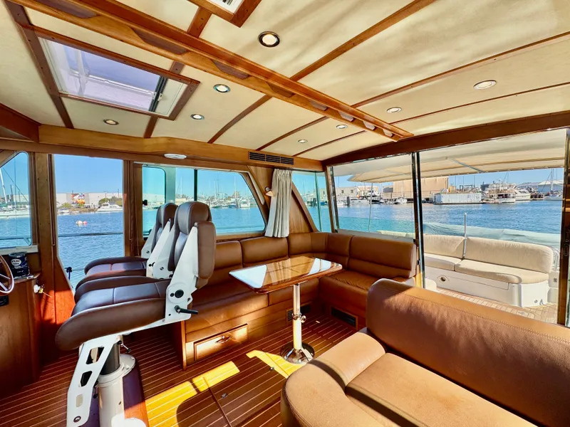 Slide: The Image of Interior of a 2016 Sabre 48 Salon Express with elegant seating and large windows overlooking the water. - 26