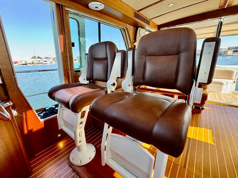 Slide: The Image of Interior of the 2016 Sabre 48 Salon Express with luxurious leather seats and wooden flooring. - 31