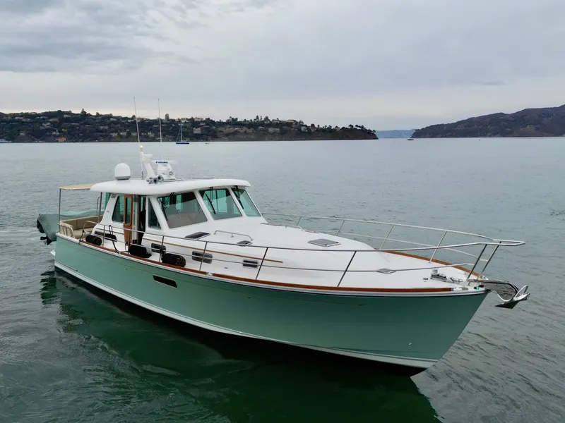 Slide: The Image of 2016 Sabre 48 Salon Express on calm water with a cloudy sky in the background. - 6