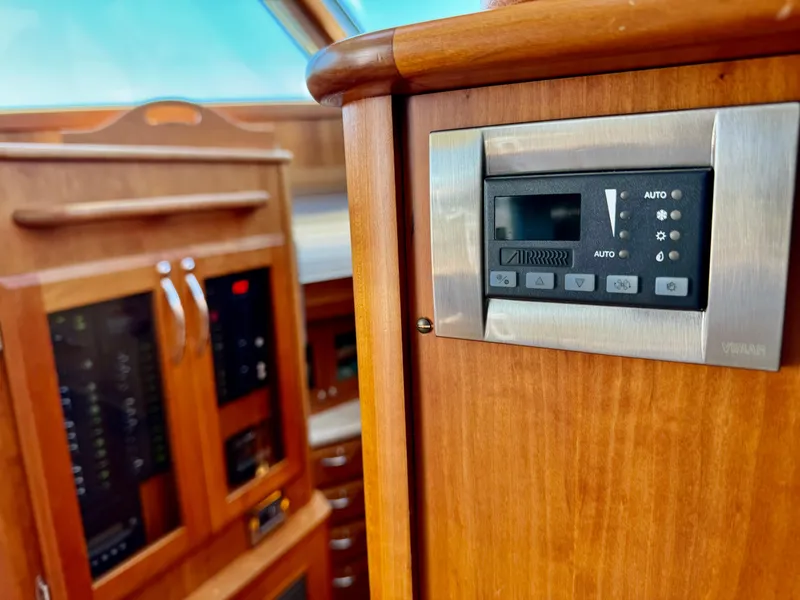 Slide: The Image of Interior of a 2016 Sabre 48 Salon Express with wood paneling and electronic controls. - 38