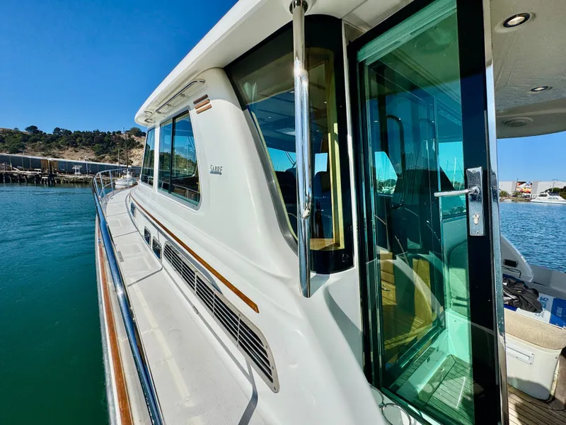 Slide: The Image of The 2016 Sabre 48 Salon Express features a sleek white exterior with large windows. - 41