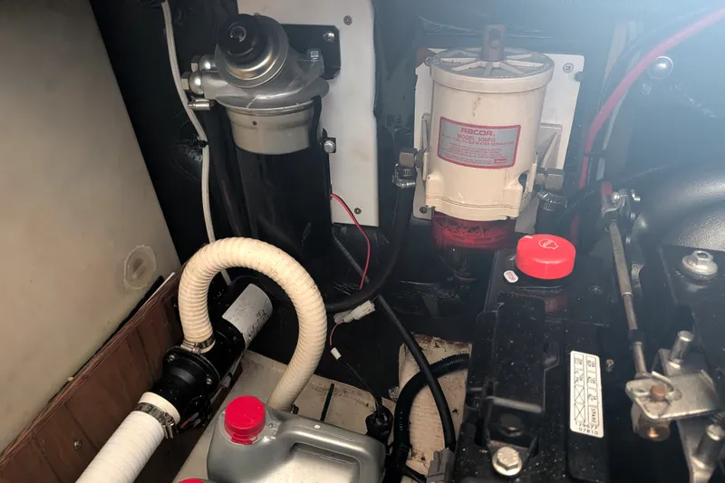 Slide: The Image of Engine compartment of a 1995 Nordic Tug 26, featuring fuel and filtration systems. - 37