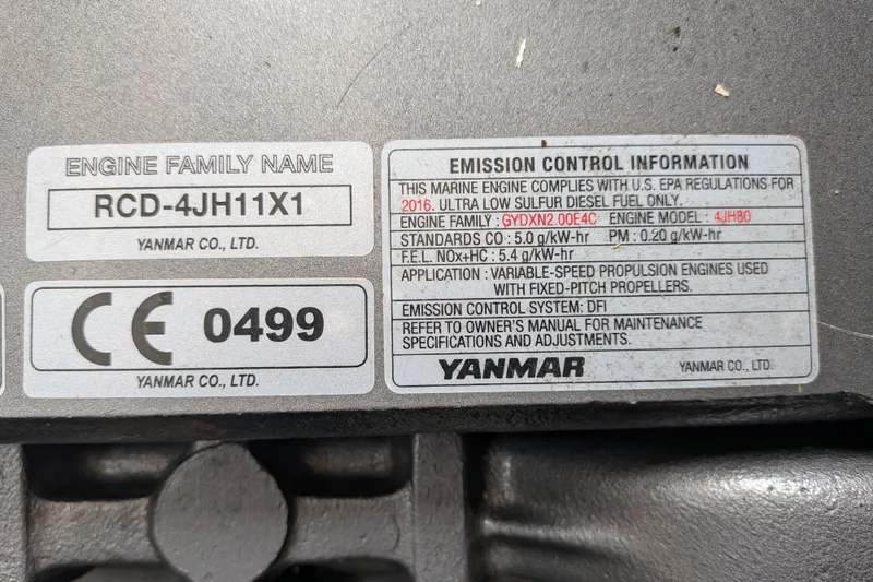 Slide: The Image of Engine label on a 1995 Nordic Tug 26, featuring Yanmar emission control details. - 39