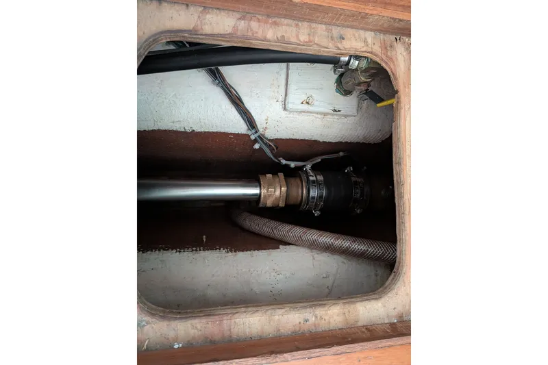 Slide: The Image of Engine compartment of a 1995 Nordic Tug 26, showing mechanical components and wiring. - 41