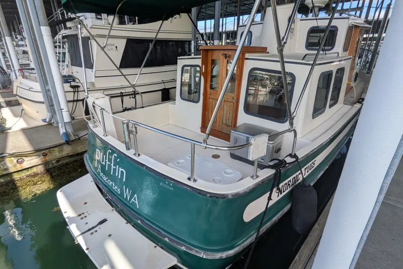 Slide: The Image of 1995 Nordic Tug 26 docked in marina, Anacortes WA, with green and white exterior. - 6