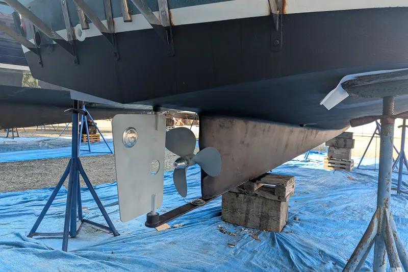 Slide: The Image of Nordic Tug 26 (1995) boat hull and propeller on stands, under maintenance. - 42