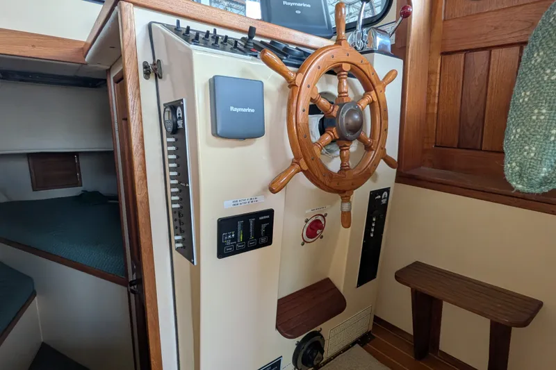 Slide: The Image of 1995 Nordic Tug 26 helm with wooden wheel and navigation equipment. - 22