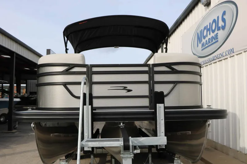 Slide: The Image of 2027 Bennington 22 S1SSR Tri Toon with black canopy, on a trailer. - 8