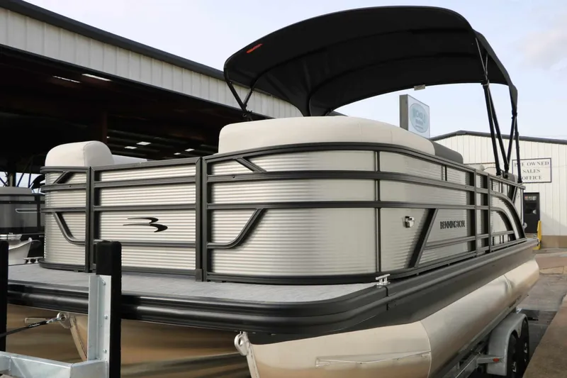 Slide: The Image of 2027 Bennington 22 S1SSR Tri Toon with sleek design and black sunshade. - 11
