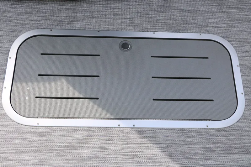 Slide: The Image of A gray, rectangular hatch with slots on a textured floor. - 43