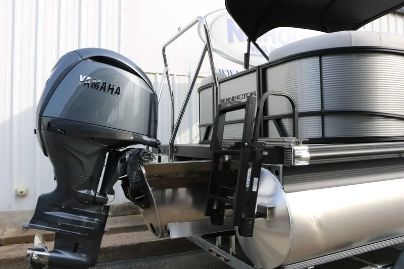 Slide: The Image of Bennington 22 S1SSR Tri Toon with Yamaha outboard motor, silver pontoons, black railing. - 21