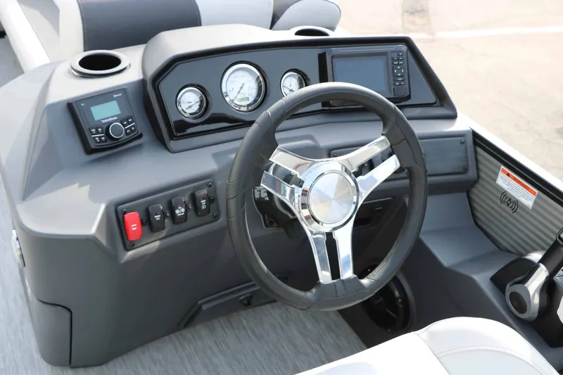 Slide: The Image of The image shows a modern boat's helm with a sleek steering wheel and instruments. - 46